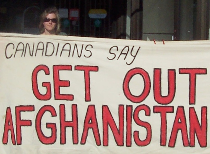 Laura Chesnik holding a banner at Windsor Ontario anti-war against Afghanistan rally 2007