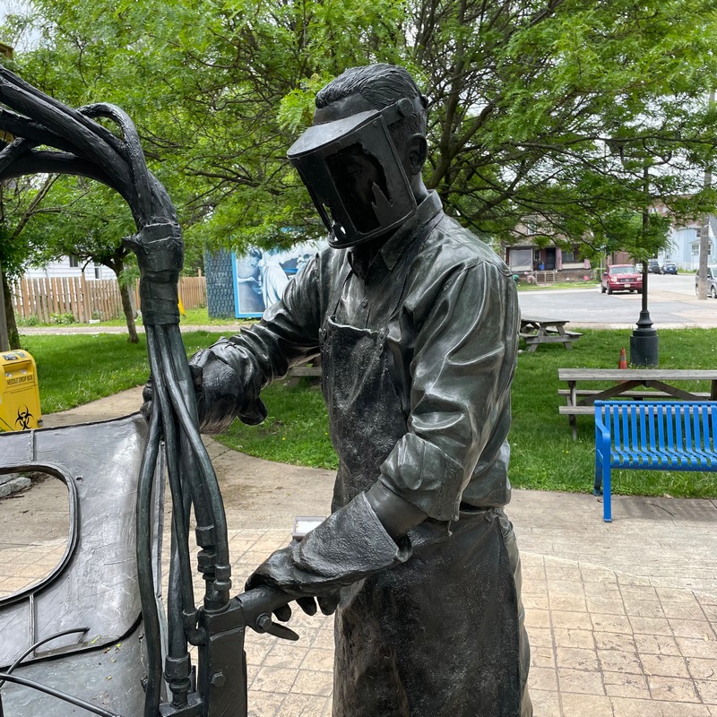 Close up of sculpture of a Ford worker assembling a vehicle