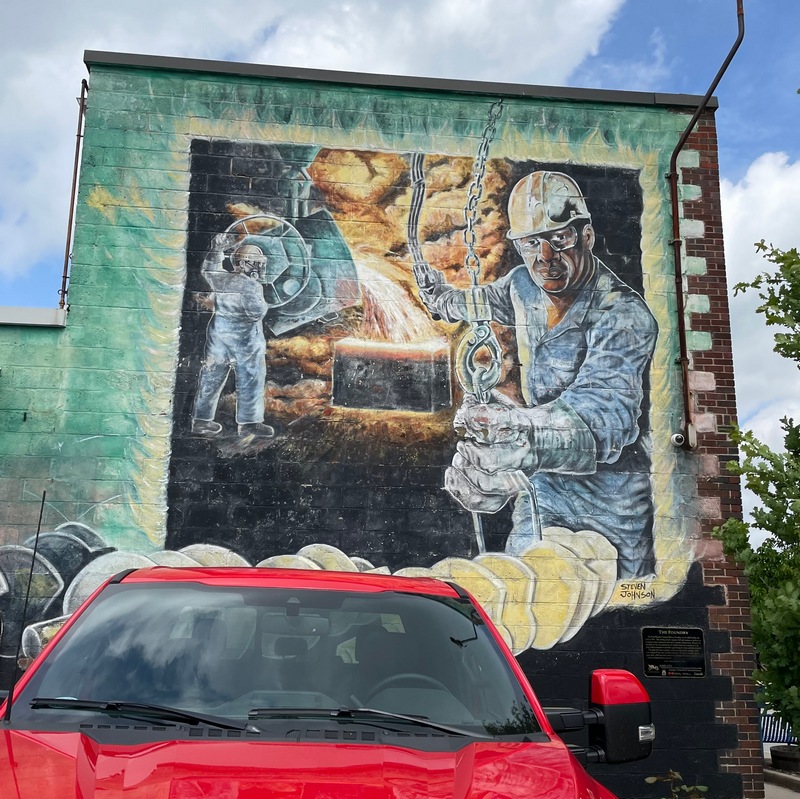 Mural in Windsor Ontario "The Foundry" One man pours molten metal into a casting and another moves the pieces down the line on a hook